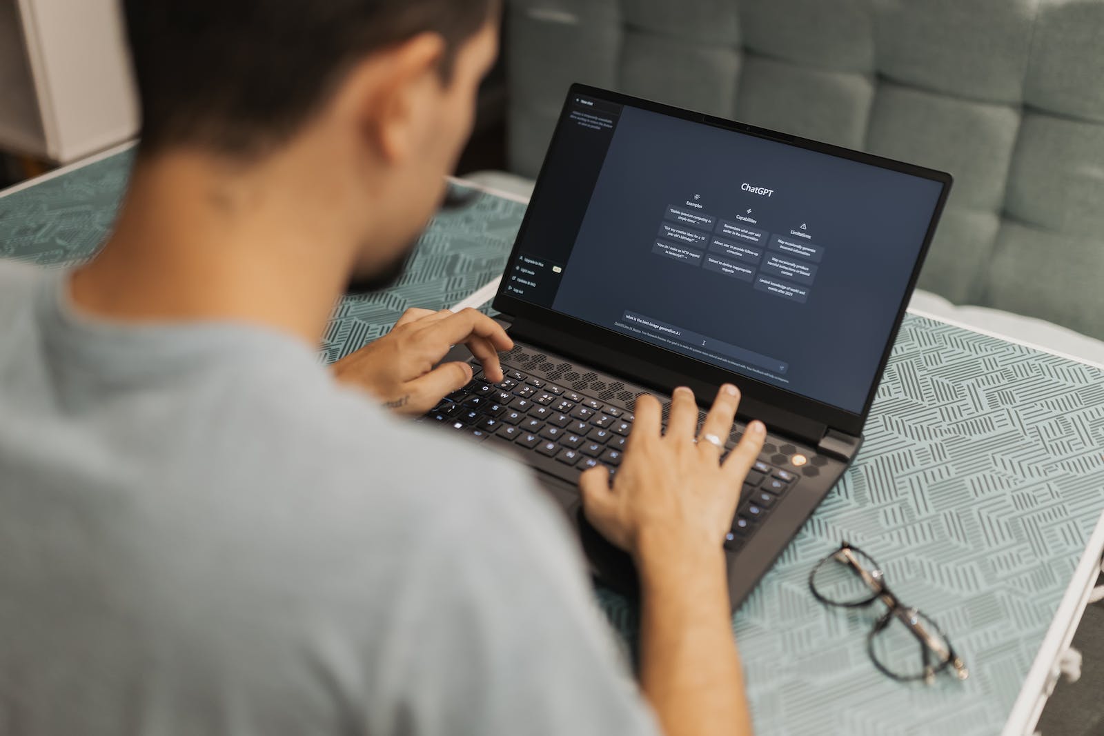 A man is typing on a laptop computer