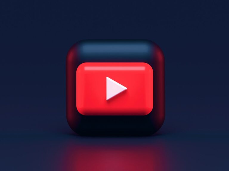 A 3D red play button icon on a dark blue background