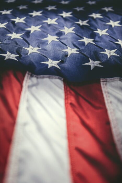 An American flag with white stars on a blue field above red and white stripes