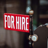 shallow focus photography of red and white for hire signage