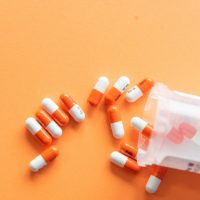 orange and white medication pill